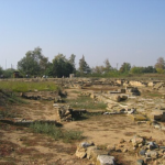 A large stone ruins in a field Description automatically generated with medium confidence